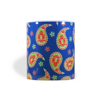 Vooraanzicht met oor aan de achterkant (niet zichtbaar) van een witte keramische mok met een paisley-patroon op een kobaltblauwe achtergrond. Het patroon bestaat uit koraalrode en limoengroene paisley-figuren, afgewisseld met kleine bloemetjes. De druppelvormige paisley-motieven zijn decoratief versierd met krullen en bloemmotieven. De onderzetter heeft afgeronde hoeken.